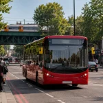 Modern London single-deck bus travelling through South London on a new limited-stop route.